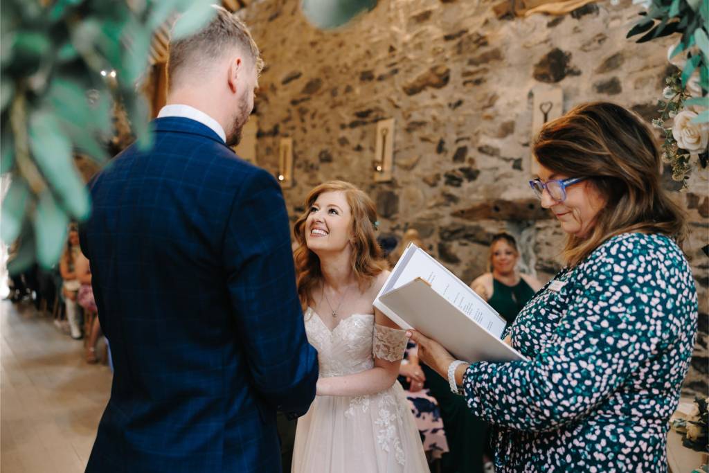 Jane reading a personal wedding ceremony script to a bride and groom