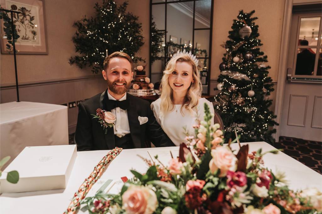 Newlyweds smiling at a festive winter wedding